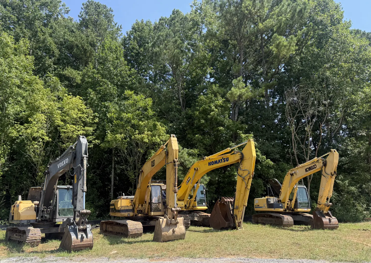 Technician grinding metal on heavy equipment with sparks